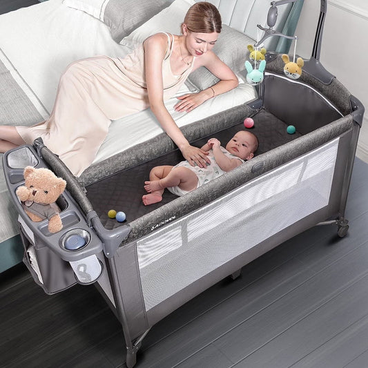 Babybond 3-in-1 Bedside Bassinet, Play Yard & Diaper Changer, suitable for newborns to toddlers aged 0-2. Comes with mattress, mosquito net, bottom diaper storage compartment and toy bar.Grey