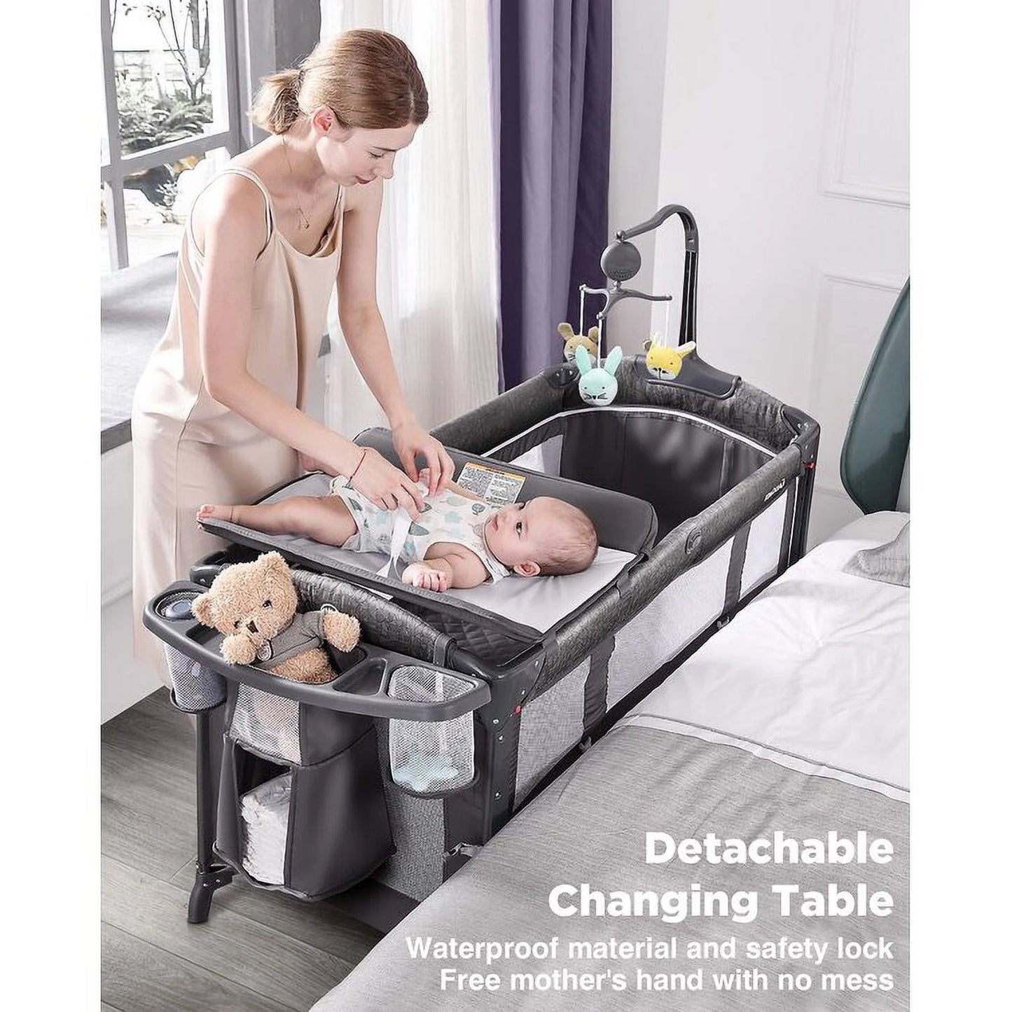 Babybond 3-in-1 Bedside Bassinet, Play Yard & Diaper Changer, suitable for newborns to toddlers aged 0-2. Comes with mattress, mosquito net, bottom diaper storage compartment and toy bar.Grey